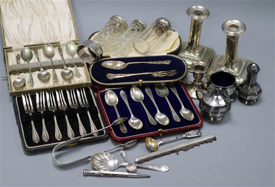 A group of assorted silver etc. including cased sets, candlesticks and toilet jars.